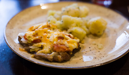 French meat with boiled potatoes served on plate