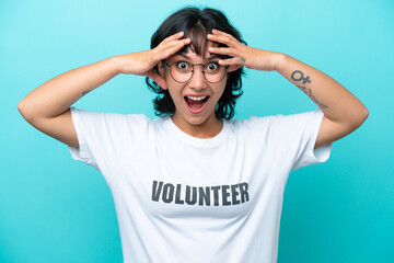 Fototapeta premium Young volunteer Argentinian woman isolated on blue background with surprise expression