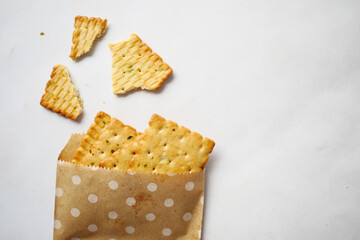 close up of sweet cookies spilling form a paper packet 
