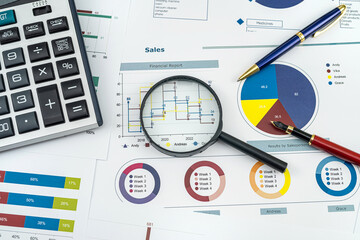 Workplace of business chart showing financial success with pen and calculator