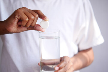 holding a Effervescent soluble tablet pills 