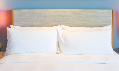 Fototapeta na wymiar Bedroom design with white pillows for travel concept
