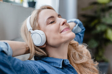 Music phone application. Closeup portrait of relaxed happy serene mature middle-aged caucasian...