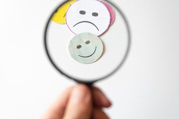 smiley face in a hand.Facial expressions on white background. Customer satisfaction concept. Don't think well.
positive idea, evaluation, rating concept.