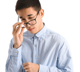 Young Asian man in eyeglasses worrying on white background
