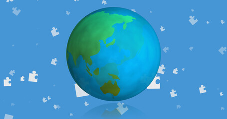 Image of blue and white puzzle pieces falling over globe on blue background