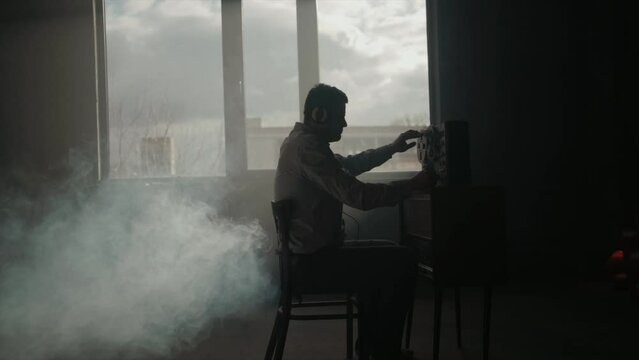 Secret agent listens on the reel tape recorder. Officer wiretapping in headphones. Spying of conversations. Intelligence gathering. Espionage concept. Report information to superiors.