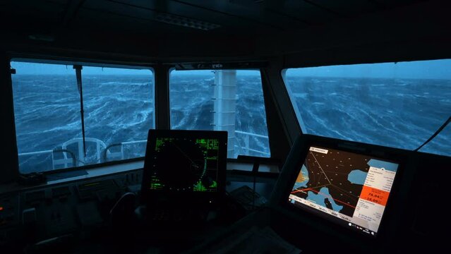 Ship in storm. Vessel bridge inside. Radar and map. Strong pitching. White foam. Sea in background.