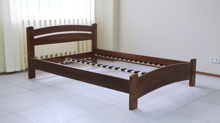 arched wooden bed with slats without mattress