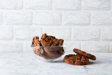 Oatmeal cookies with chocolate chips on a light background. Breakfast concept.