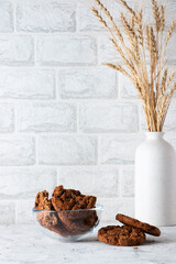 Oatmeal cookies with chocolate chips on a light background. Breakfast concept.