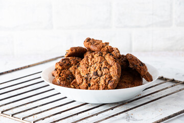 Oatmeal cookies with chocolate chips on a light background. Breakfast concept.