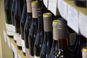 Wine bottles on wooden shelf in wine store, View from the top