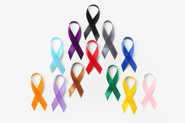 Many colorful awareness ribbons on white background. World Cancer Day concept