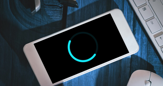 Image of loading circle on smartphone in office