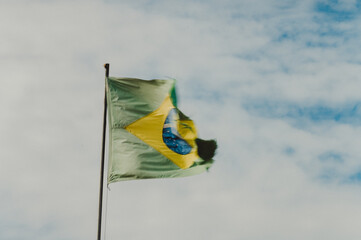 Brazil's flag in a clouded sky, torn