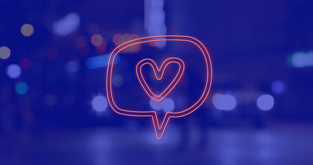 Image of heart icon over cityscape at night on blue background