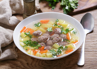 plate of soup with meatballs