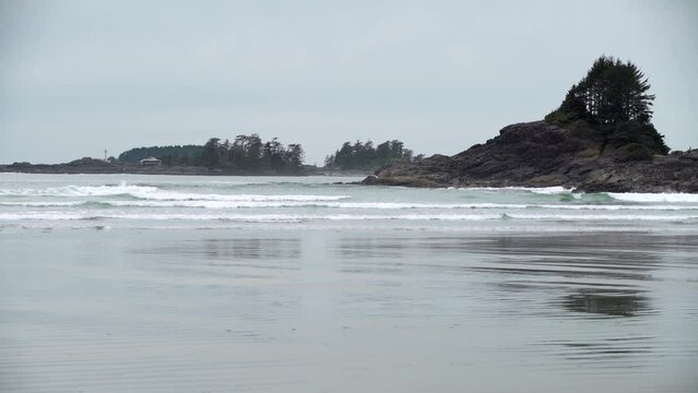 West Coast Vancouver Island Cox Bay Surfers 4K UHD. Surfers on Cox Bay on the west side of Vancouver Island in Tofino. 4K UHD.

