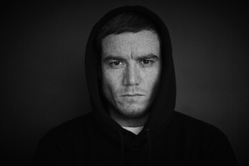 portrait of attractive middle aged men in a black hoodie. strong man portrait. Black-and-white photo.