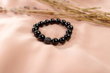 Decoration is a bracelet made of black agate. Natural stone jewelry