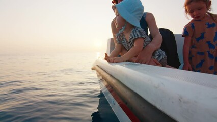 Extended family with kids fishing in the open calm sea from the boat