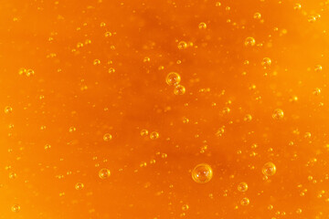 Macro honey bubbles close-up bright amber color. The texture of honey. The concept of healthy eating. Diet.