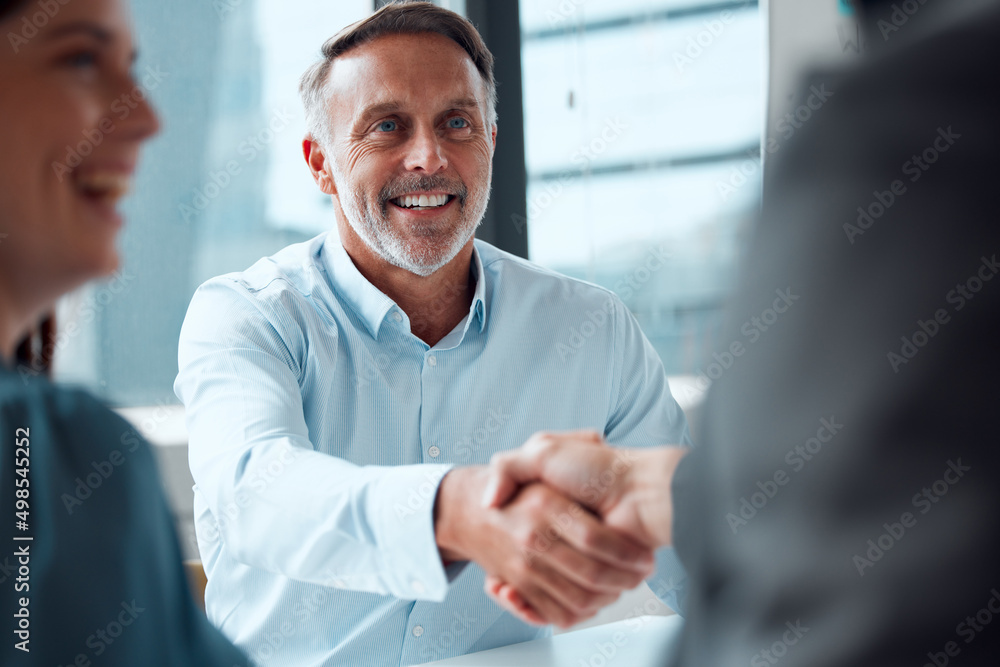 Poster recognising and commending the efforts of his team. shot of a mature businessman shaking hands with 