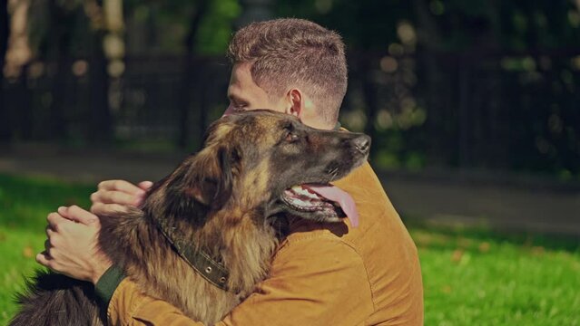 Man hugging and petting german shepherd dog, friendship between dog and human