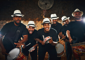 Were here to entertain you tonight. Portrait of a group of musical performers playing drums...