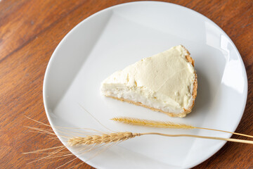 Clear Coconut Cream Pie in the dish on the wood table without anything topping on it. Shooting in the sunlight.