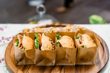 A group of homemade HAMBURGER is wrapped with paper craft and arranged on the dish, ready to serve and eat.