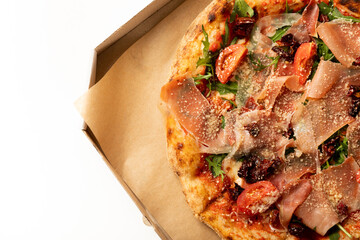 Banner close-up of Delicious pizza in a box on a white background. Top view of hot pizza. With copy space for text.