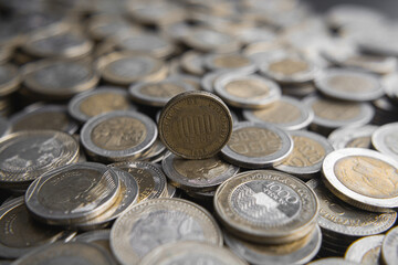Stacks of Colombian coins of 500 and 1000 pesos denominations, money devaluation
