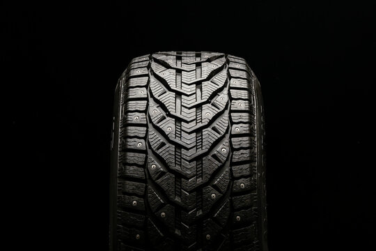 new winter studded tire on a black background