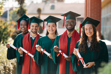 Portrait of happy graduating classmates with certificates looking at camera.