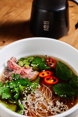 fresh clear soup with cilantro noodles chili pepper and meat, pho bo top view