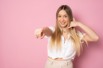 Young beautiful blonde woman wearing casual shirt over pink isolated background smiling doing...