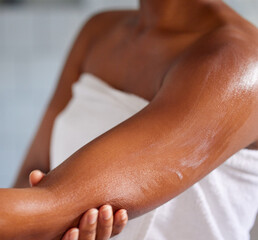 Hydrating moisturisers have saved my skin. Shot of a woman massaging lotion into her skin.