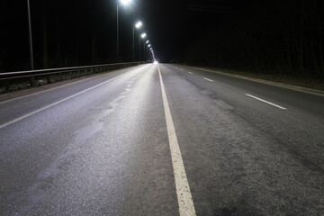 Road with lampposts against a night sky
