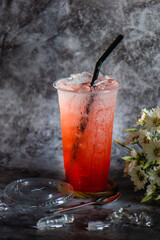 Strawberry iced soda in a plastic cup