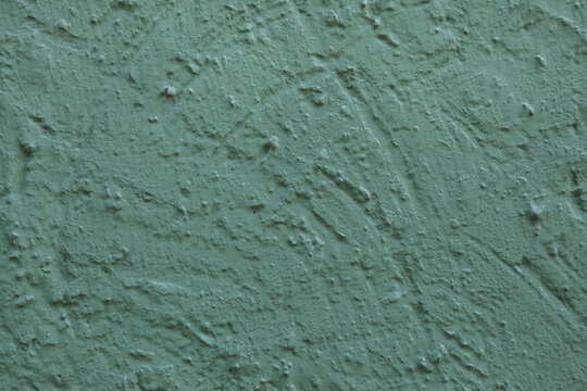 Green painted stucco wall. Background texture