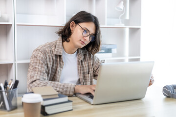 Young studying online uses his laptop in a live performance to communicate with his friends and teachers, Using laptops and data graphs in class, Online communication, Social distancing.