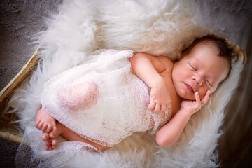 Cute sleeping in the basket newborn baby boy