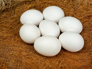 Farm fresh chicken eggs on natural burlap. Close-up.