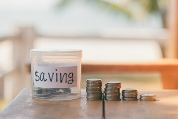 Saving money concept, White plastic money saving jar and coins with copy space, Saving money for the future in business or travel in holiday or personal life concept,Green nature day light background.