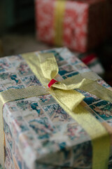 Beautiful Christmas gift boxes wrapped with gift paper and a bow. A gift under the Christmas tree. The concept of the new year
