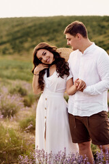 beautiful young couple walking on a lavender field