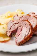 slices of meat served with potatoes