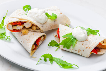tortilla filled with chicken meat, red pepper and beans